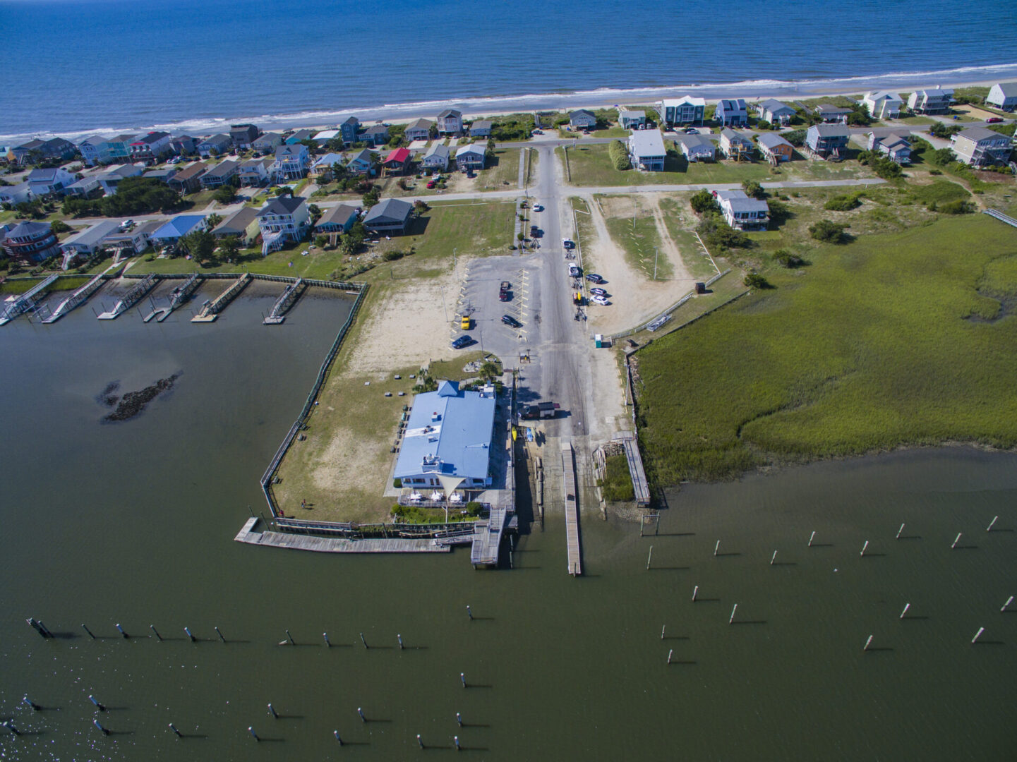 An aerial view of a beach with houses and water.