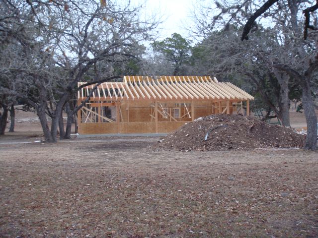 A wooden structure that is being built in the woods.