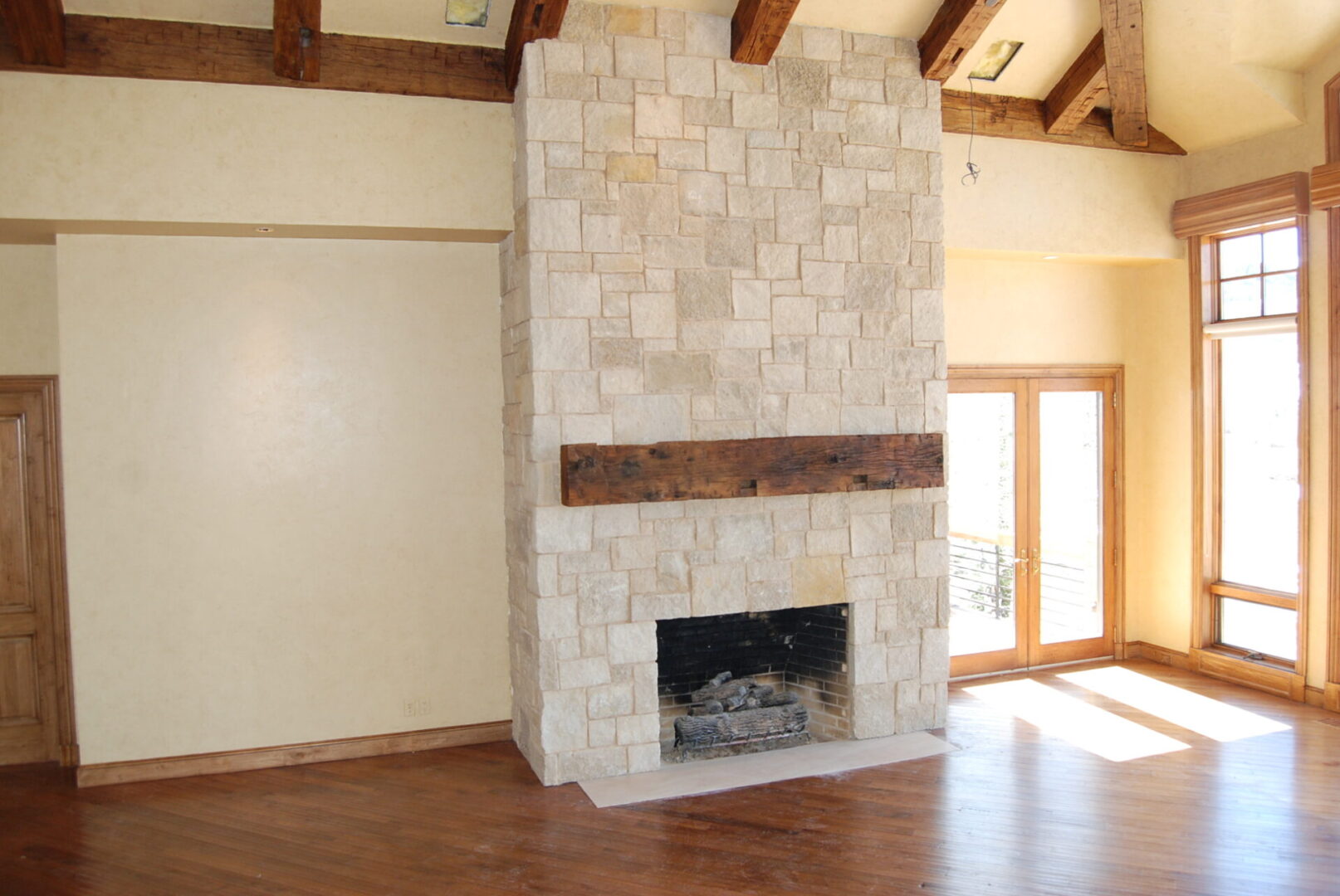 A fireplace with wood mantle and tile surround.