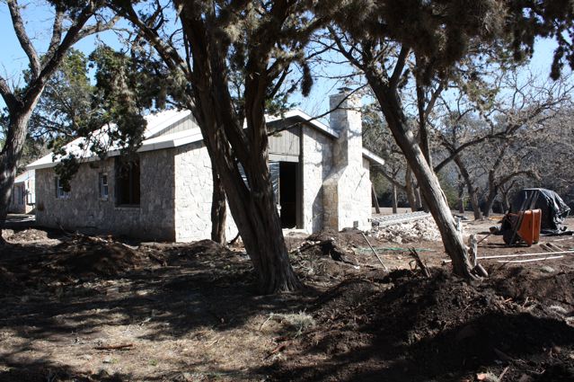 A house that is being built in the dirt.