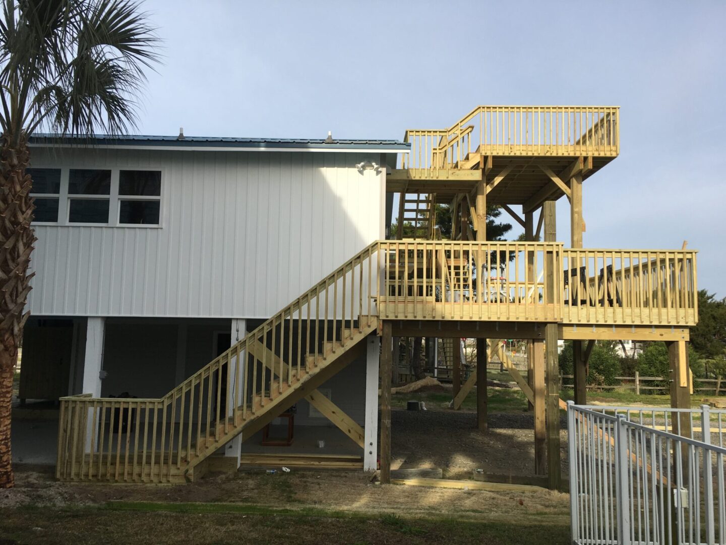 A house with stairs going up to the top of it.