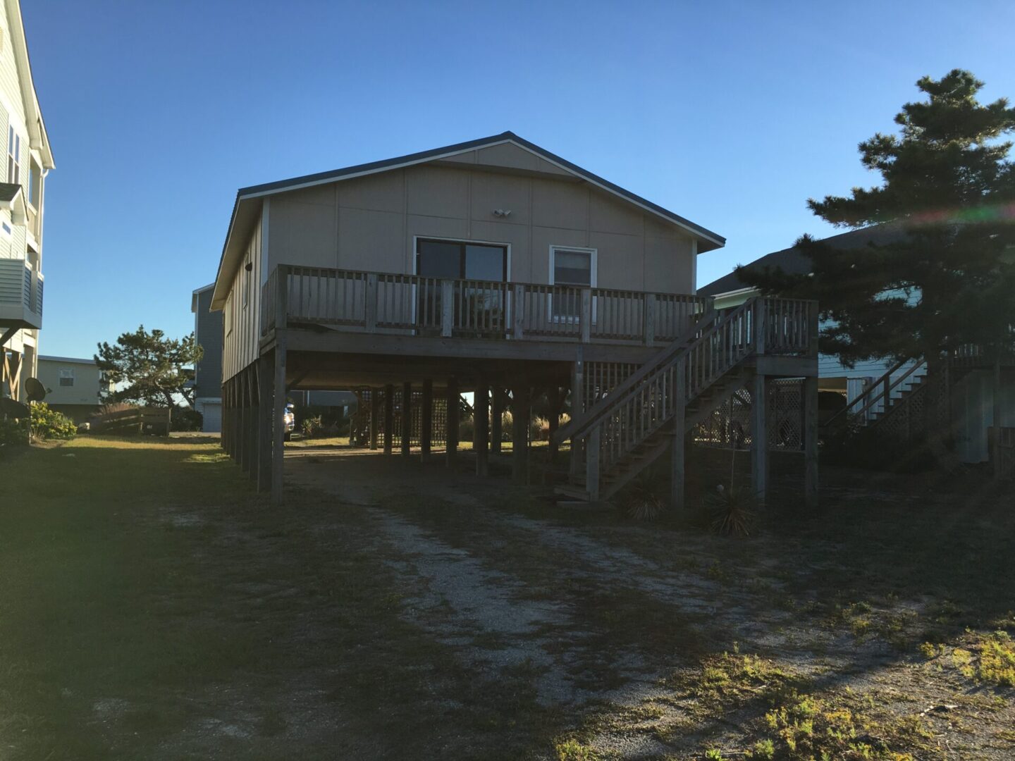 A house with stairs going up to the top of it.