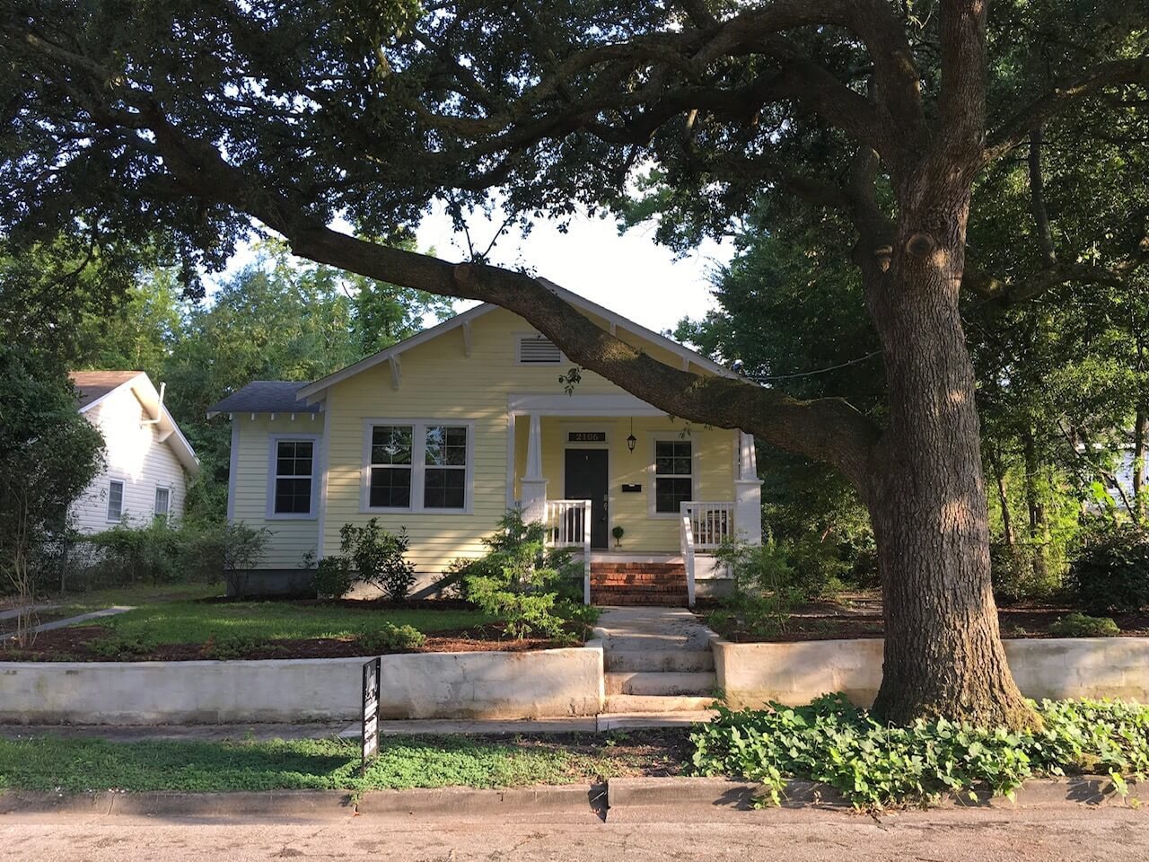 A house with a tree in front of it
