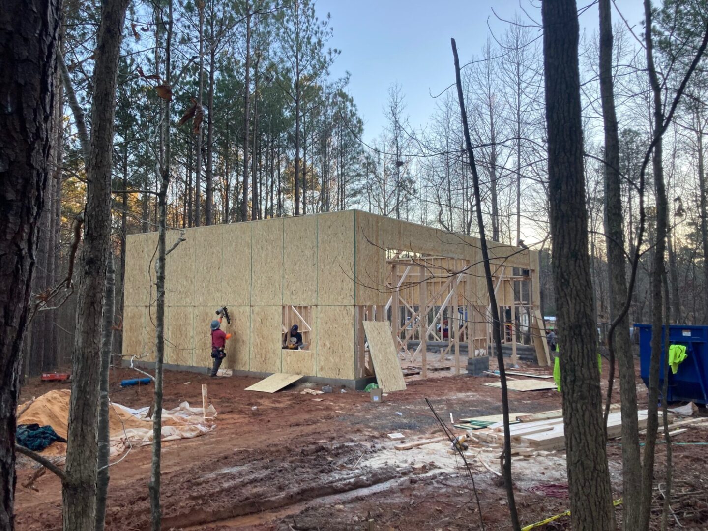 A person standing in front of a building under construction.