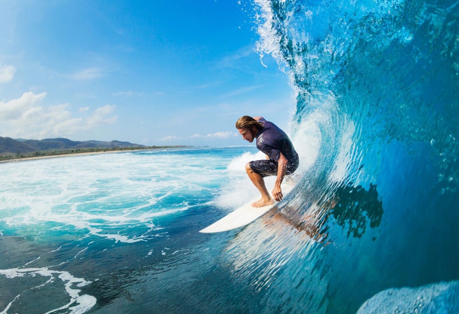 A man riding on top of a surfboard in the ocean.